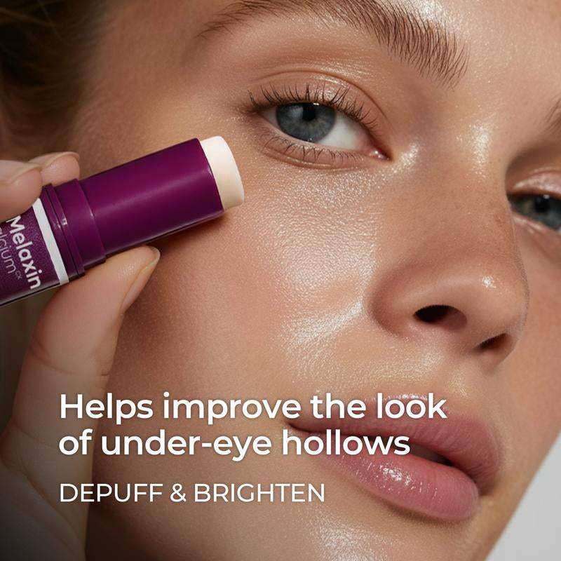 Calcium Multi Balm eye stick in a purple twist-up tube, applied beneath the eye for de-puffing care