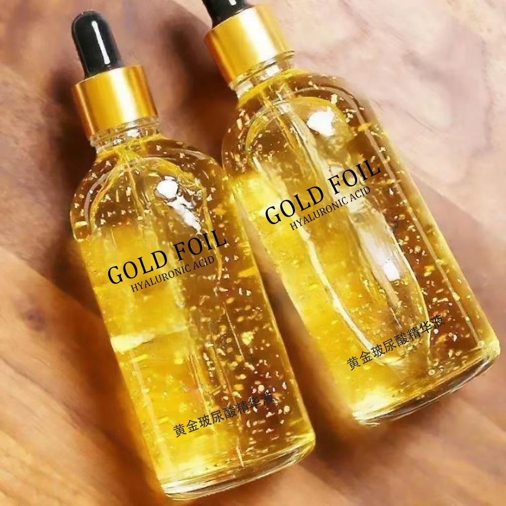 24K Gold Face Serum in clear glass dropper bottles, with golden serum and visible gold flakes for a radiant finish