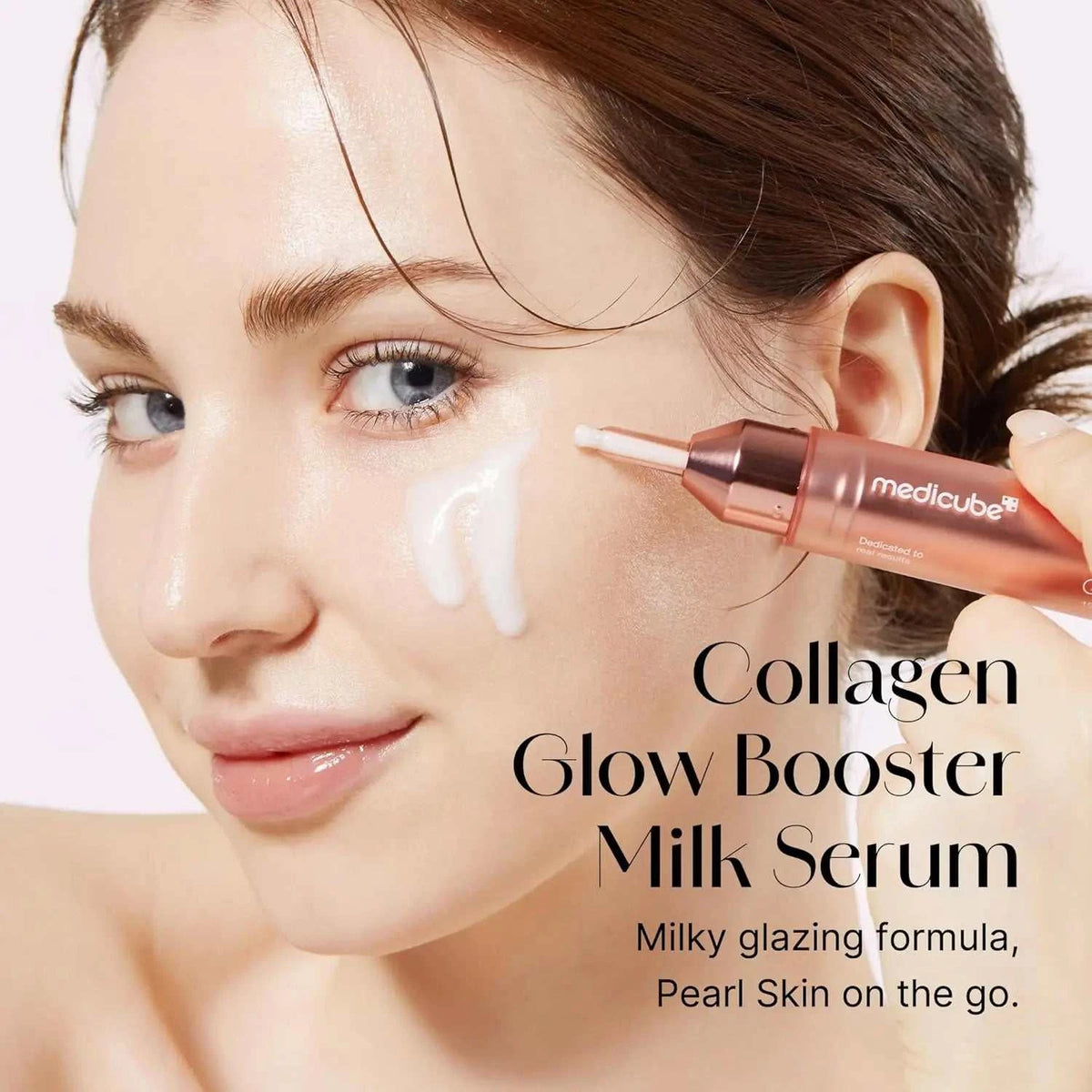 Collagen Glow Booster Milk Serum in a rose-gold tube, shown with creamy white serum applied to the cheek