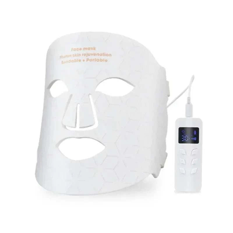 LED Light Therapy Facial Mask in white silicone with geometric pattern, eye and mouth cutouts, and wired controller