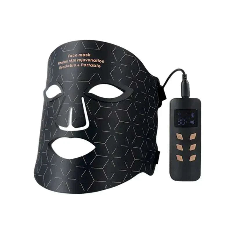 LED Light Therapy Facial Mask in black silicone with geometric pattern, eye and mouth cutouts, and handheld controller