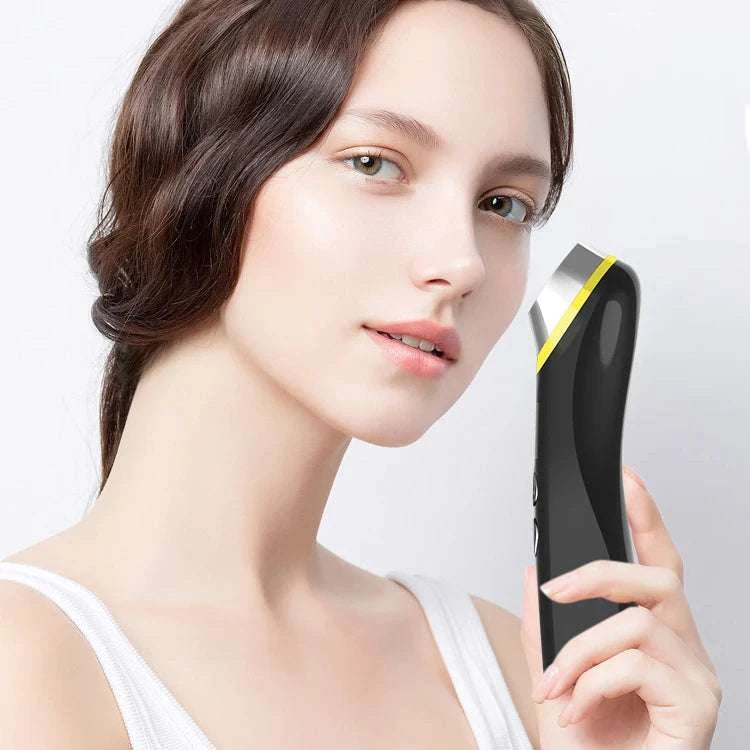 Facial beauty device in black plastic with a yellow accent, curved ergonomic body, and Glass Glow Booster brandingાવે