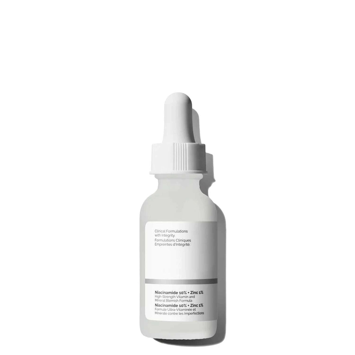 Niacinamide serum dropper bottle in a white container with a minimalist label featuring 10% Niacinamide and zinc