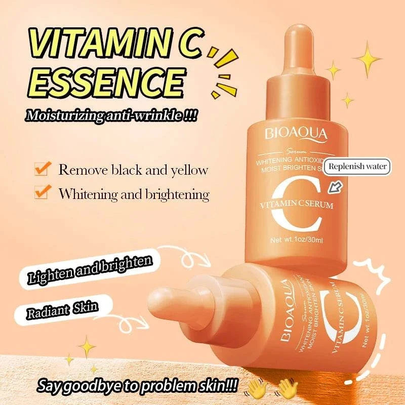 Facial Essence Serum in peach-orange glass dropper bottles, with white Vitamin C and brightening text on the label