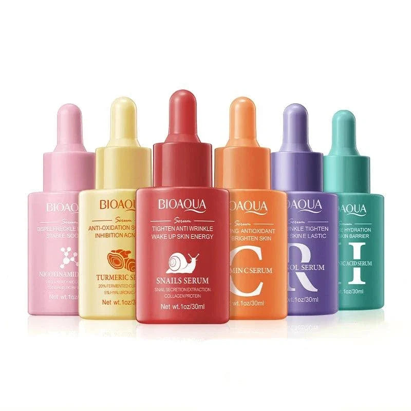 Facial Essence Serum in colorful glass dropper bottles, featuring pink, yellow, red, orange, purple, and teal packaging with labeled formulas.
