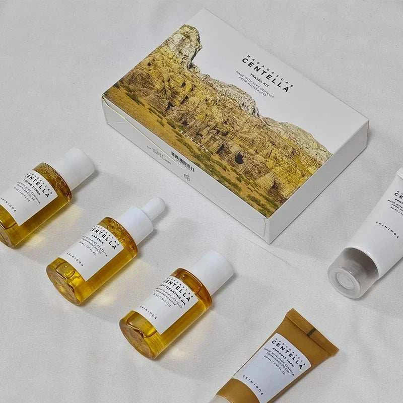 Centella Travel Skincare Kit with amber dropper bottles, white tubes, and illustrated box packaging