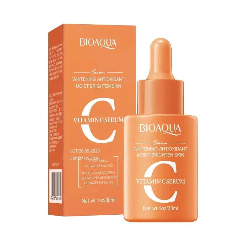 Facial Essence Serum in a translucent orange dropper bottle and matching box, with a large white vitamin C label.