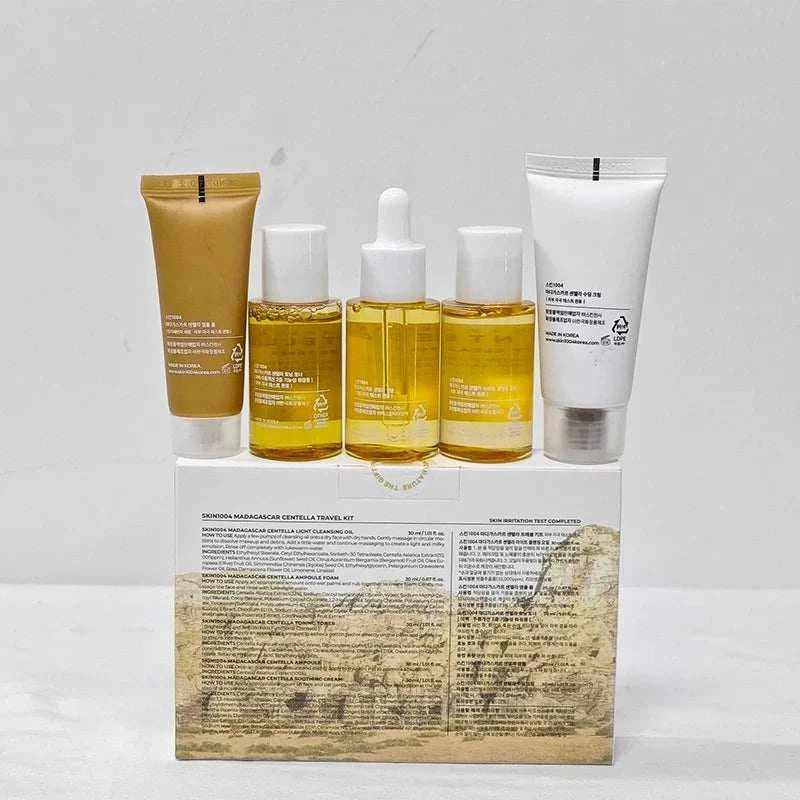 Centella Travel Skincare Kit with five amber and white bottles and tubes in a printed box, travel-size set