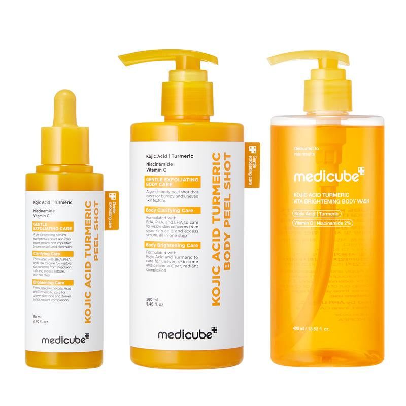 Kojic Acid Turmeric Peel Shot skincare trio with yellow serum dropper and pump bottles, white labels