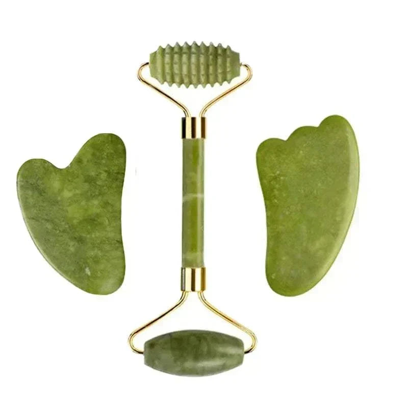 Jade facial massage set in mottled olive green stone, with a double-ended roller and two smooth gua sha tools