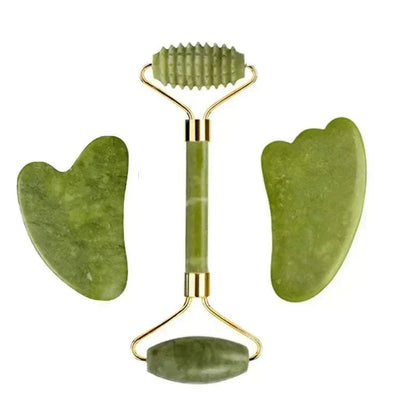 Jade facial massage set in mottled olive green stone, with a double-ended roller and two smooth gua sha tools