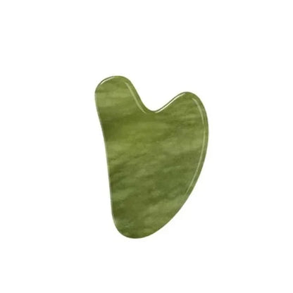 Gua sha facial massage tool in Natural Xiuyan Jade, polished green stone with subtle cloudy bands and a notched edge