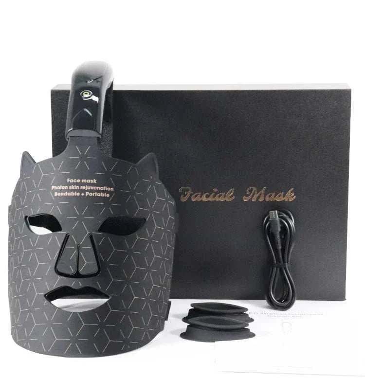 Silica Handheld Mask in black silicone with geometric pattern, ergonomic design, and accompanying black box, cord, and accessories